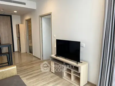 Modern living room with sleek TV setup and wooden flooring