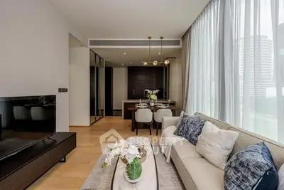 Luxurious modern living room with elegant decor and large windows offering city views.