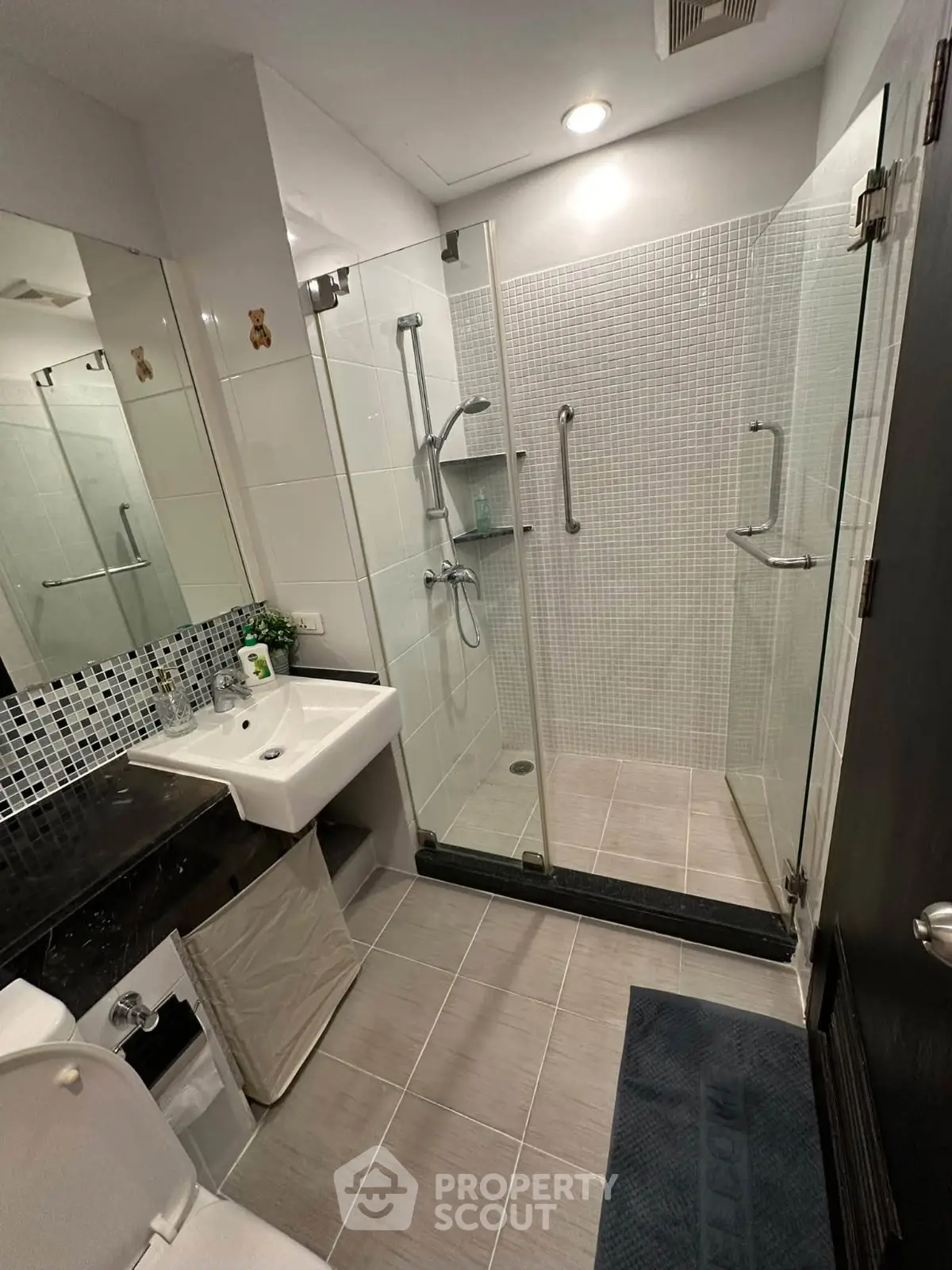 Modern bathroom with glass shower enclosure and sleek fixtures
