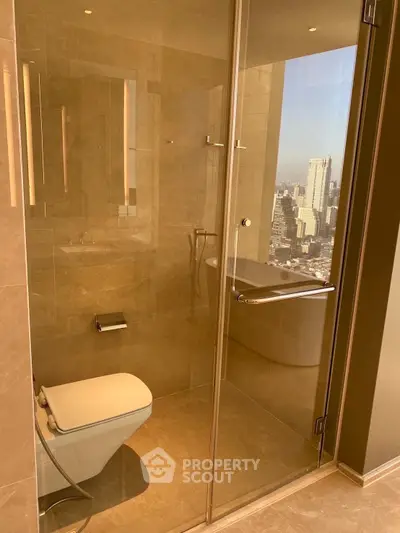 Luxurious bathroom with city view, featuring modern glass shower and elegant fixtures.