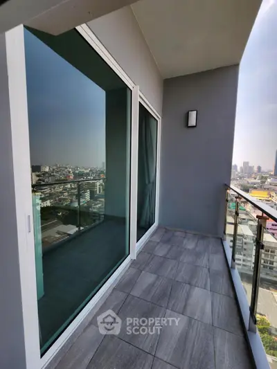 Spacious balcony with city view in modern high-rise apartment