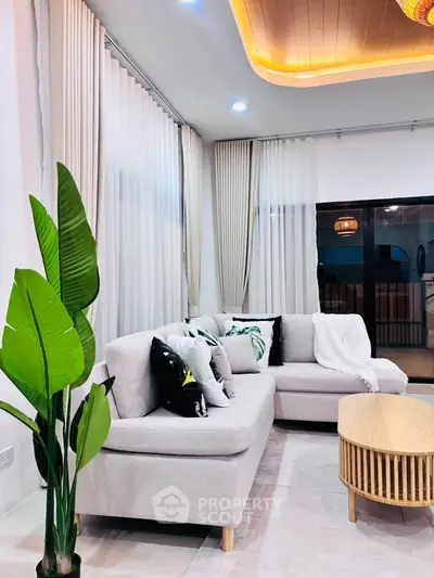 Modern living room with stylish sofa, elegant curtains, and contemporary lighting