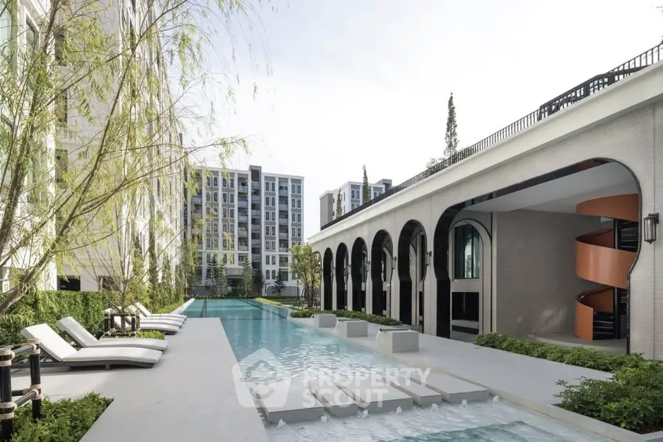 Luxurious modern apartment complex with pool and stylish architecture.