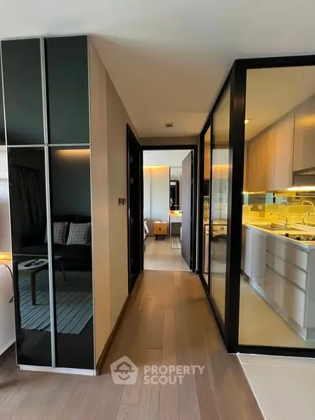 Modern apartment hallway with sleek kitchen and cozy living area