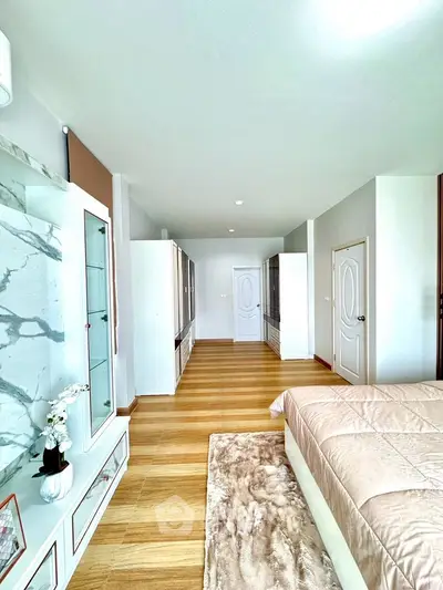 Spacious bedroom with elegant decor and ample natural light