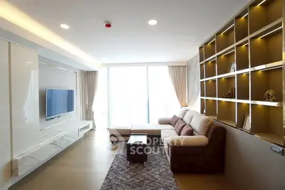 Modern living room with stylish shelving and large windows for natural light.