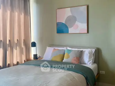 Cozy bedroom with modern decor and soft lighting, perfect for relaxation.