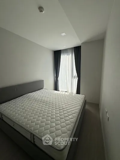 Spacious bedroom with natural light and modern decor