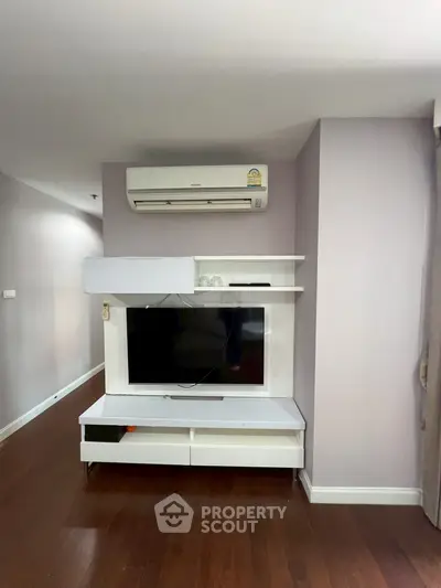 Modern living room with sleek TV unit and air conditioning, perfect for comfortable living.