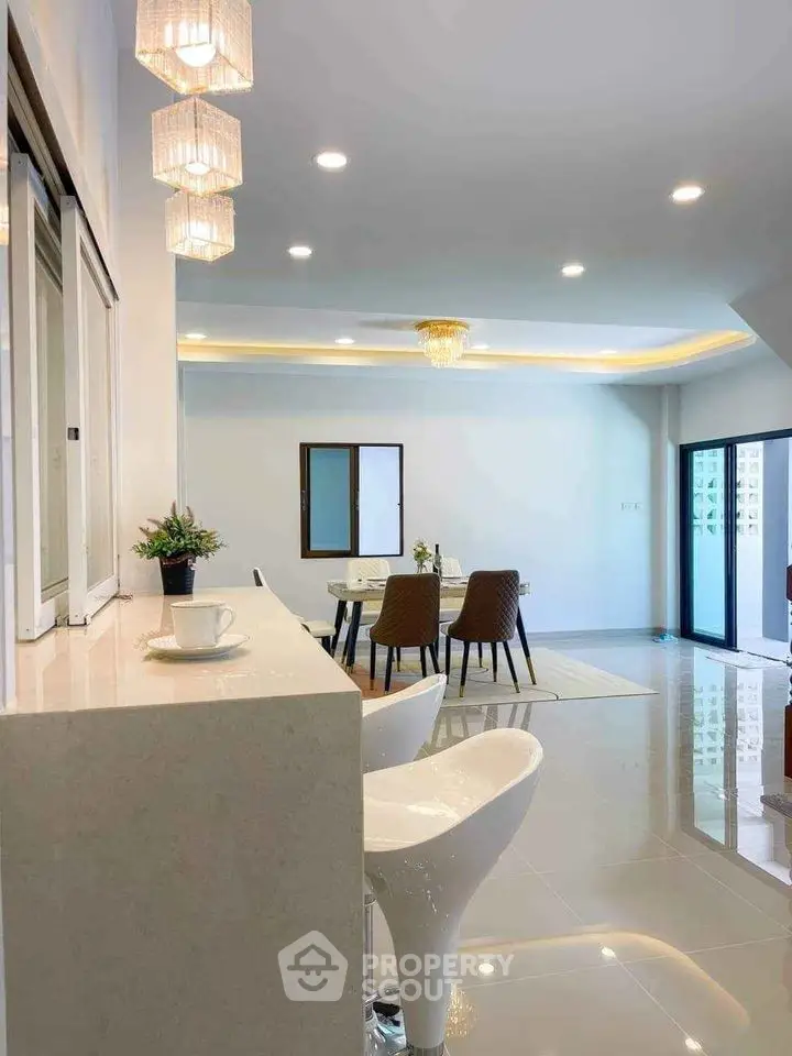 Modern open-plan living and dining area with stylish decor and natural light.