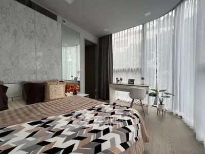 Modern bedroom with stylish decor and large window for natural light