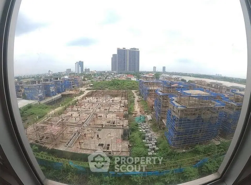 Panoramic view of urban construction site with high-rise buildings in the background.
