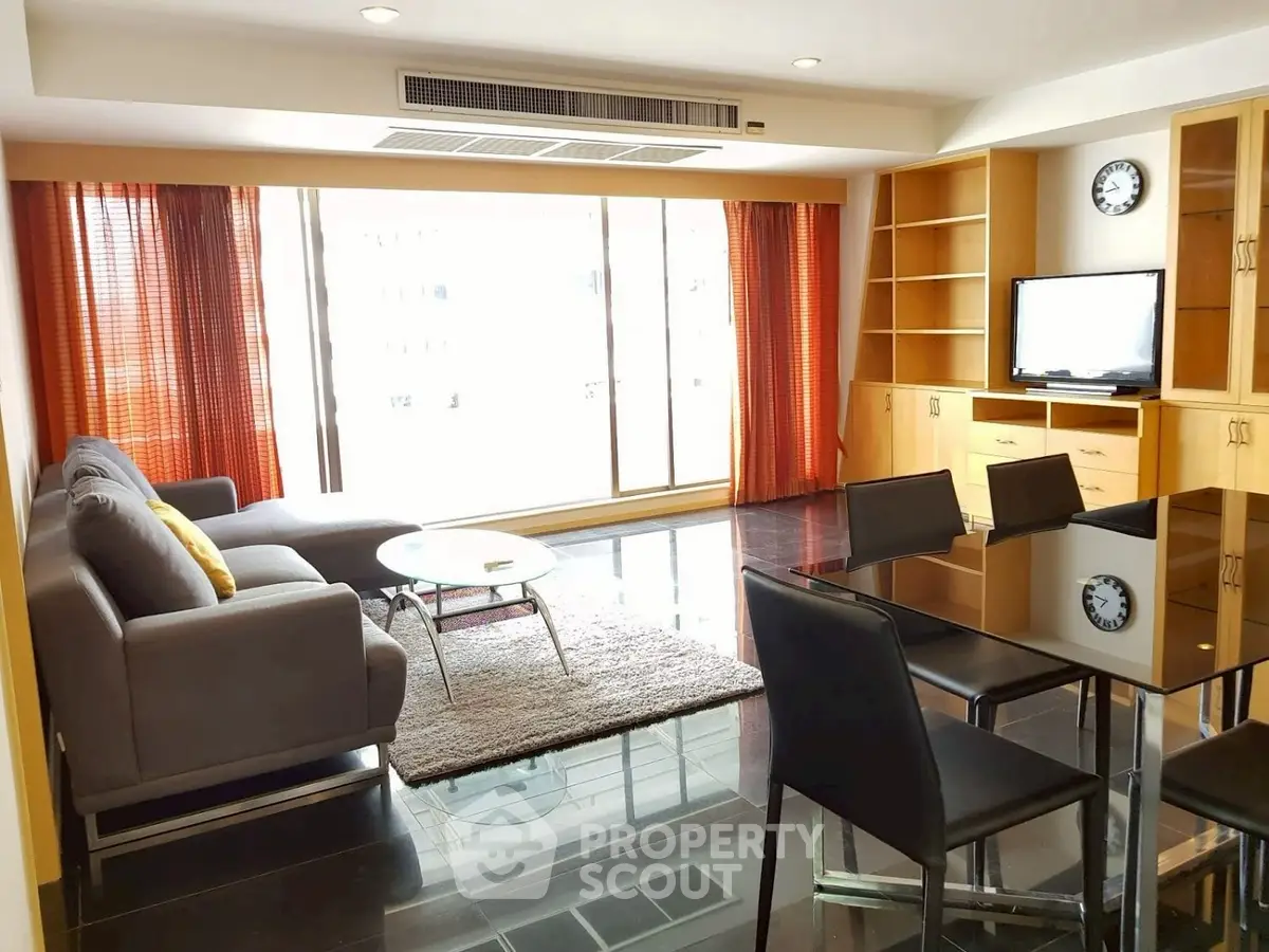 Spacious living room with modern furniture and large windows for natural light