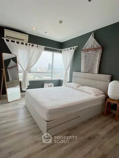 Modern bedroom with large window and city view, featuring stylish decor and natural light.