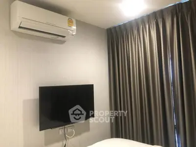 Modern bedroom with air conditioning and wall-mounted TV