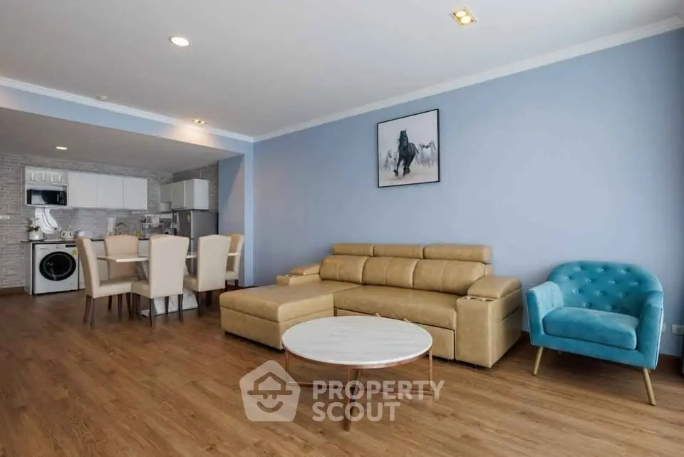 Spacious living room with modern furniture and open kitchen layout