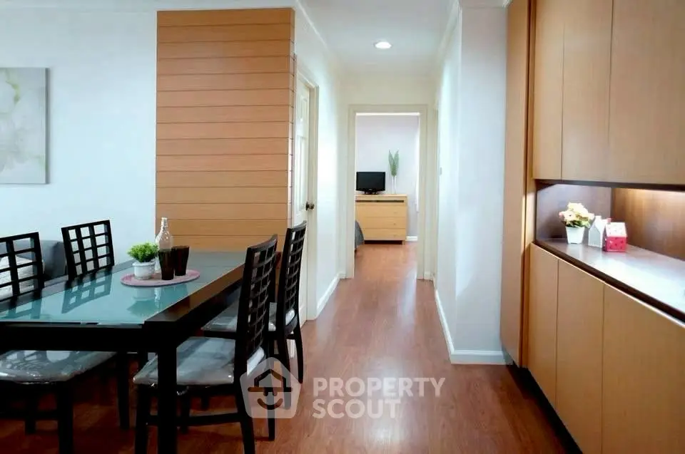 Modern dining area with wooden flooring and sleek cabinetry