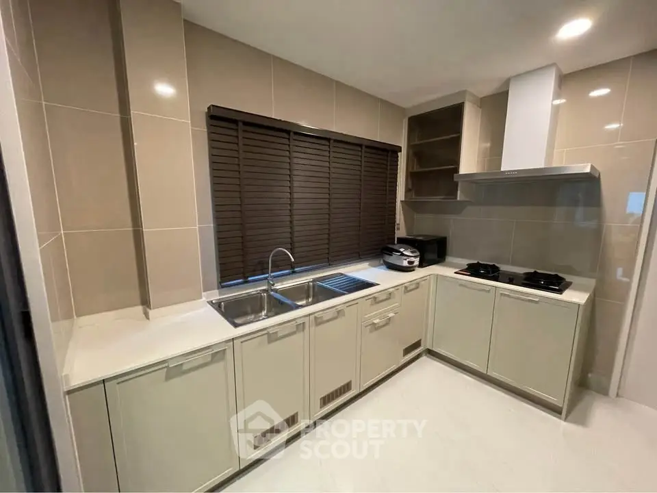 Modern kitchen with sleek cabinetry and gas stove in a stylish home