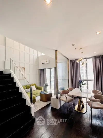 Luxurious modern living room with elegant dining area and stylish staircase in high-rise apartment.