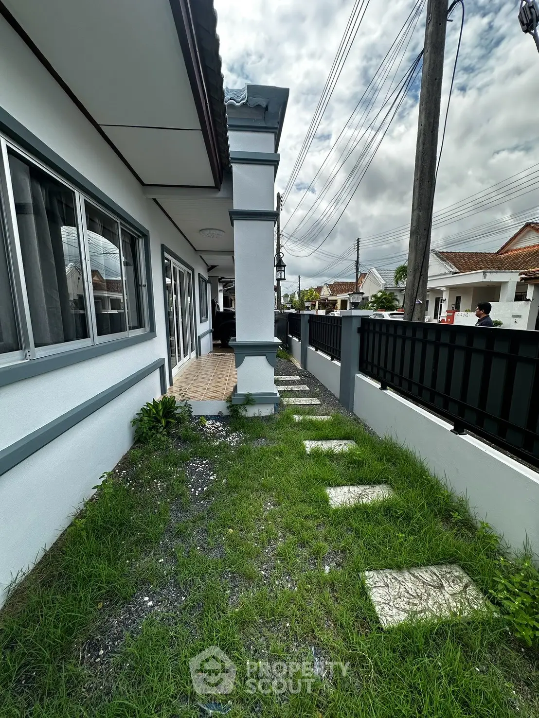 Charming suburban home with lush green lawn and modern exterior design, perfect for family living.