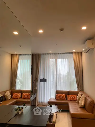 Modern living room with stylish decor and large windows in a luxury apartment.