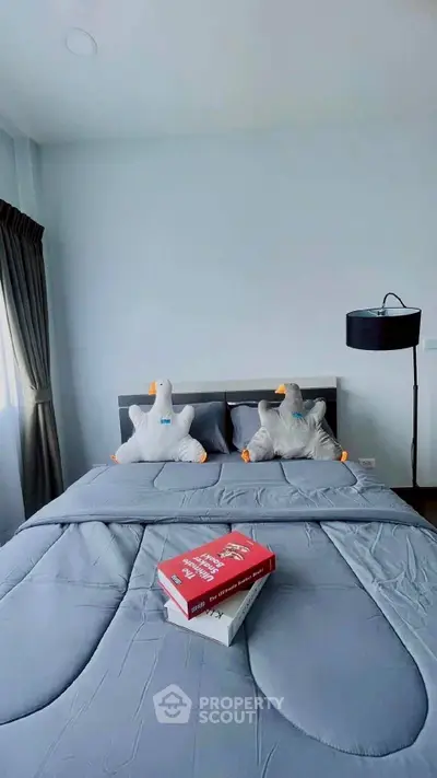 Cozy bedroom with stylish decor and plush bedding, perfect for relaxation.