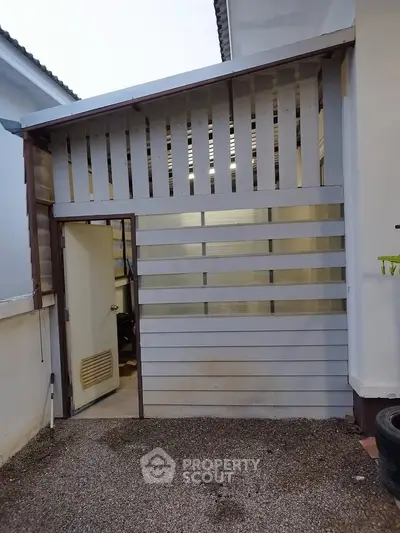 Modern exterior with unique slatted design and open entrance, perfect for creative outdoor space.