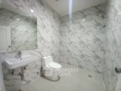 Luxurious marble bathroom with modern fixtures and spacious design