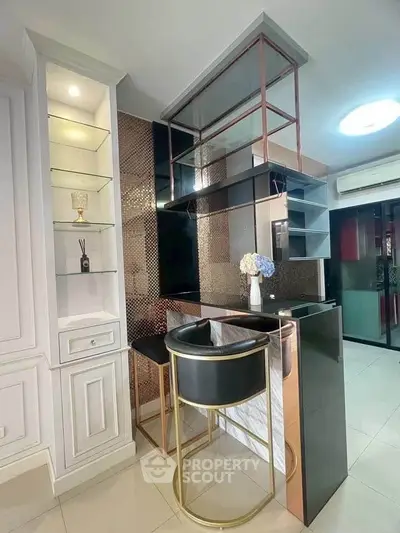 Modern kitchen with sleek bar counter and elegant shelving in a stylish apartment.