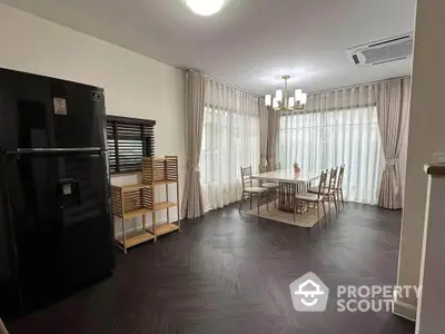 Elegant dining area with modern furniture and large windows in a stylish home