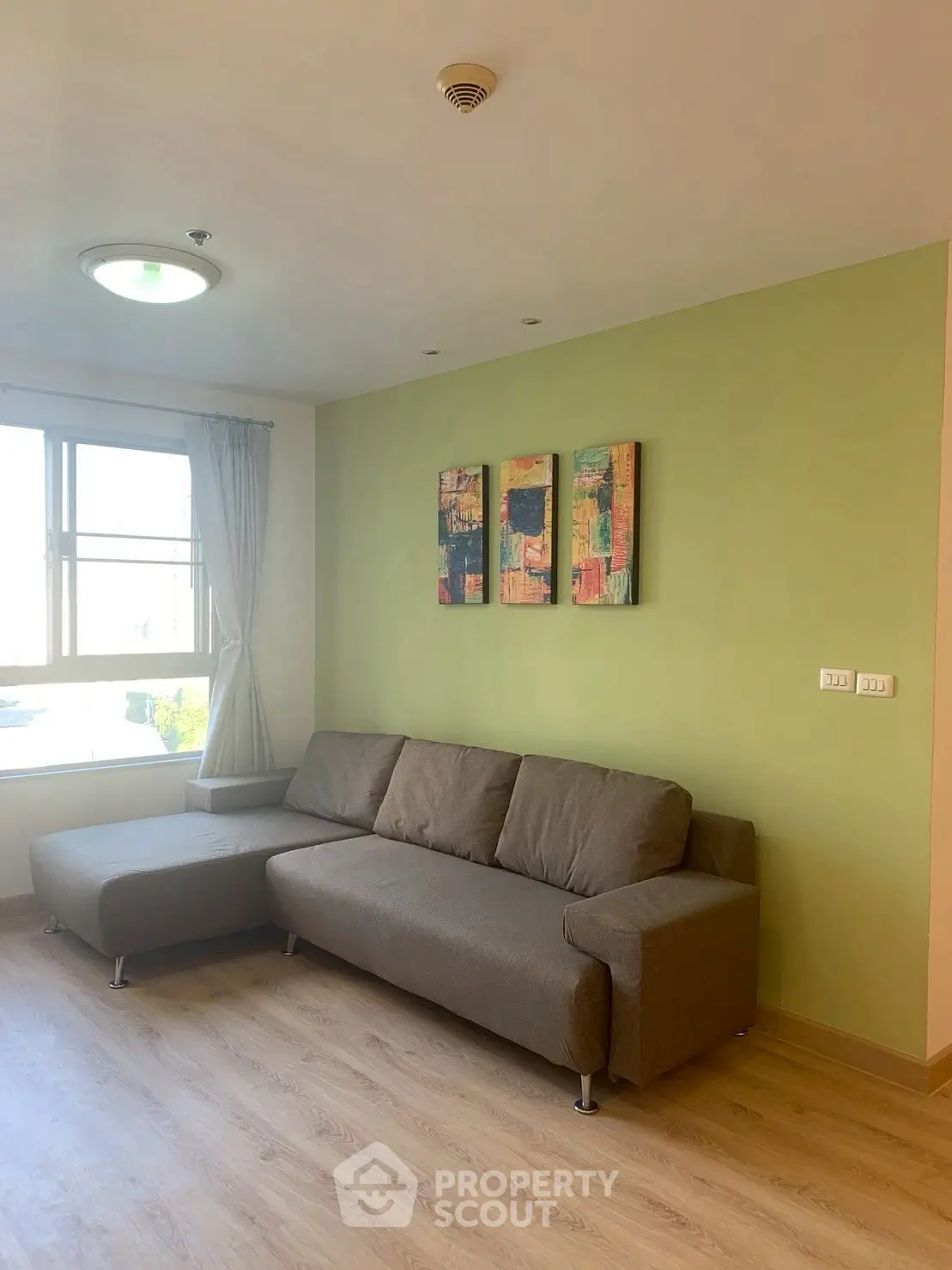 Modern living room with stylish sofa and vibrant wall art