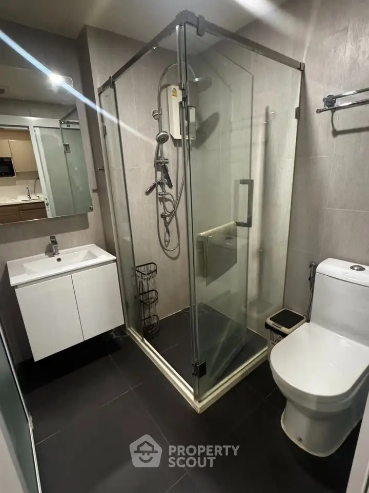 Modern bathroom with glass shower enclosure and sleek fixtures
