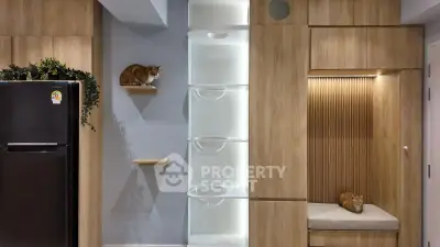 Modern kitchen with wooden cabinetry and built-in cat shelves