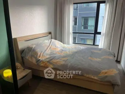 Cozy bedroom with large window and modern decor in urban apartment