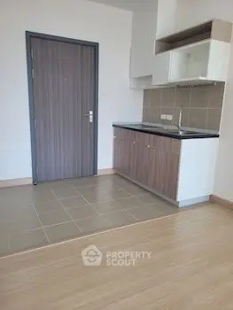 Modern compact kitchen with sleek cabinetry and tiled flooring