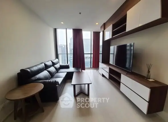 Modern living room with sleek furniture and city view, perfect for urban living.