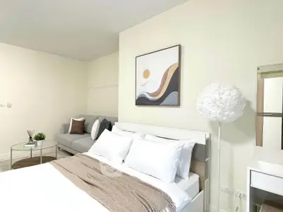 Modern bedroom with stylish decor and cozy seating area