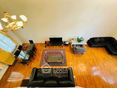 Spacious living room with elegant chandelier and hardwood floors