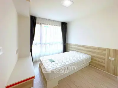 Bright minimalist bedroom with large window and modern decor