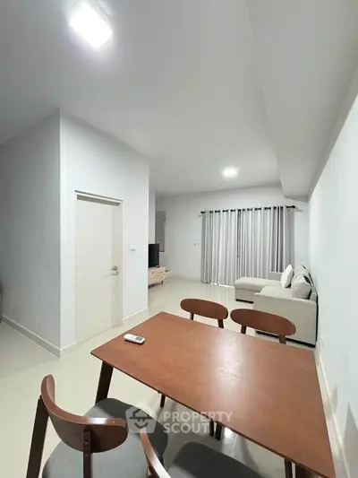 Modern living room with sleek furniture and neutral tones, perfect for relaxation and entertainment.