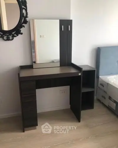 Modern bedroom with stylish vanity and mirror, perfect for contemporary living.