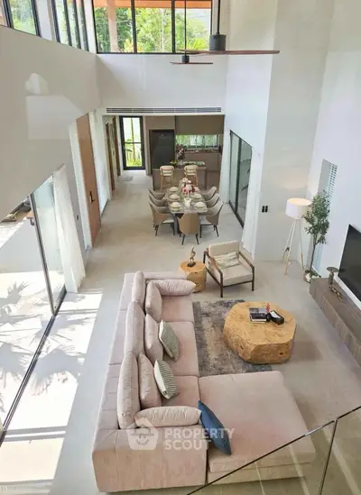 Luxurious open-plan living room with elegant dining area and modern decor