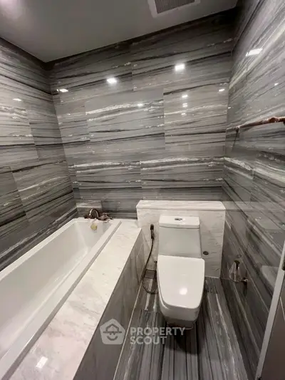 Luxurious bathroom with marble walls and modern fixtures