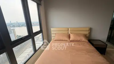 Modern bedroom with river view and large windows in a high-rise apartment.