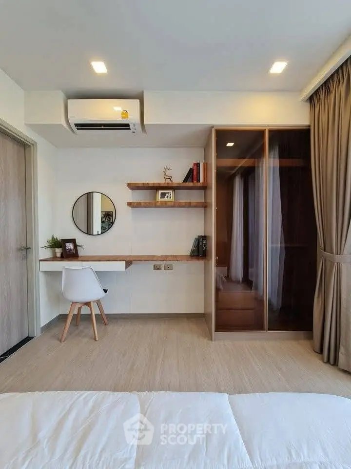 Modern bedroom with built-in desk, stylish shelving, and elegant wardrobe design.