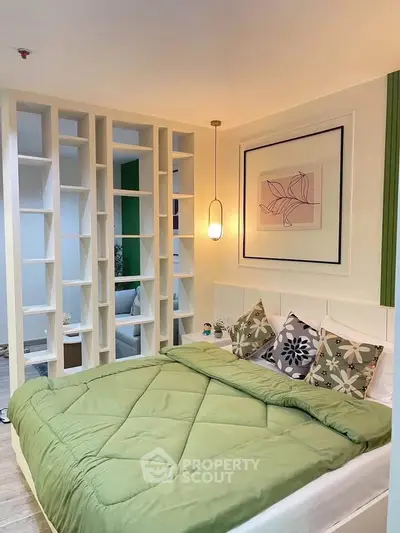Modern bedroom with stylish decor and cozy green bedding, featuring a unique open shelving design.