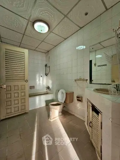Spacious bathroom with vintage tiles and classic fixtures