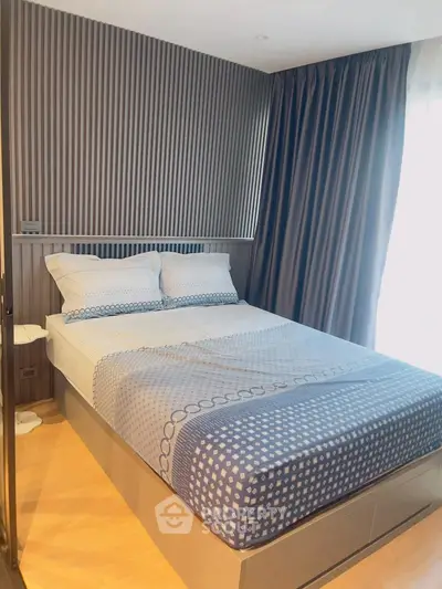 Modern bedroom with stylish decor and cozy bedding in a well-lit space.