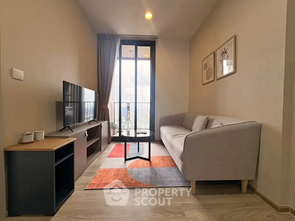 Modern living room with stylish decor and balcony view in a high-rise apartment.