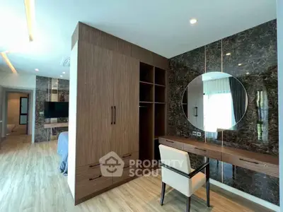 Luxurious bedroom with elegant wood finishes and stylish vanity area